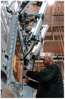 Chemistry division employee Louie Salazar operates the hot cell manipulators in the new Isotope Production Facility at the Los Alamos Neutron Science Center.