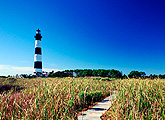 A boardwalk through marshes leads to the Bodie Island Light in the Outer Banks of North Carolina 