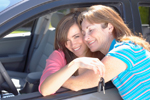Photo: teen girl holding car keys hugging her mom