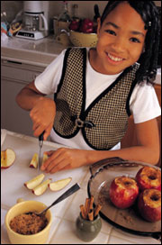 Young girl slicing an apple