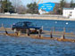 Photo of a car crossing a nearly submerged causeway along the New Hampshire coast.