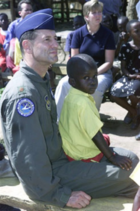 Servicemembers from the Heidelberg Army Installation, Germany, spends time with one of the 92 children who live at the Open Door Children&#39;s Home in Uganda. They  and more than 30 other U.S. service men and women visited Open Door while deployed to Uganda for MEDFLAG 02.  
(Photos by SSgt. Kimberly Drake)