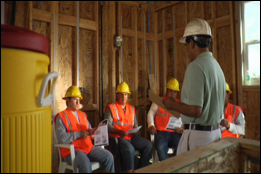 trainer talking with construction workers