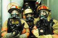 Firefighters wear respirators and carry special high-intensity lights to perform difficult tasks.