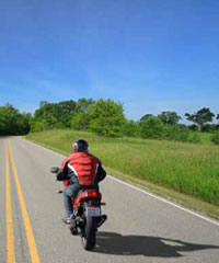 Photo: Person driving a motorcycle on the open road
