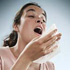 A woman sneezing