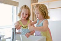 Photo: Two girls washing their hands.