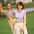 A woman laughing on the golf course