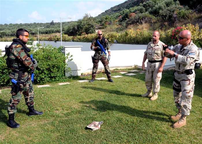 SOUDA BAY, Crete (May  27, 2011)  â? Greek Special Forces Ens. Alexander Tsaltas, right, an instructor at the NATO Maritime Interdiction Operational Training Center (NMIOTC), instructs members of the Greek navy maritime interdiction operations boarding team how to properly advance on a potentially-uncooperative member of a suspect vessel&#39;s crew during a Phoenix Express 2011 (PE-11) defense tactics exercise in Souda Bay, Crete .  A three-week exercise divided into two phases of training, PE-11 is designed to enhance regional maritime partnerships among the 13 participating nations in their efforts to deter illicit trafficking at sea.  (U.S. Navy photo by Mass Communication Specialist 2nd Class (SW) Jeff Troutman/Released)