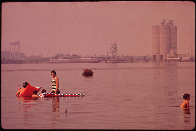 Swimming in Polluted Lake Charles. Olin-Mathieson Plant in Background 06/1972 Documerica by Marc St. Gil (1924-1992).