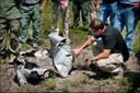 Investigators look over the remains of a steel drum destroyed by an improvised explosive device as part of their studies during a post-blast school hosted recently by the FBI in St. Augustine, Florida.