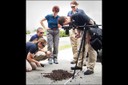 Keeping their skills sharp, FBI Jacksonville Evidence Response Team members review and practice proper procedures and techniques for photographing tire impressions in soil.