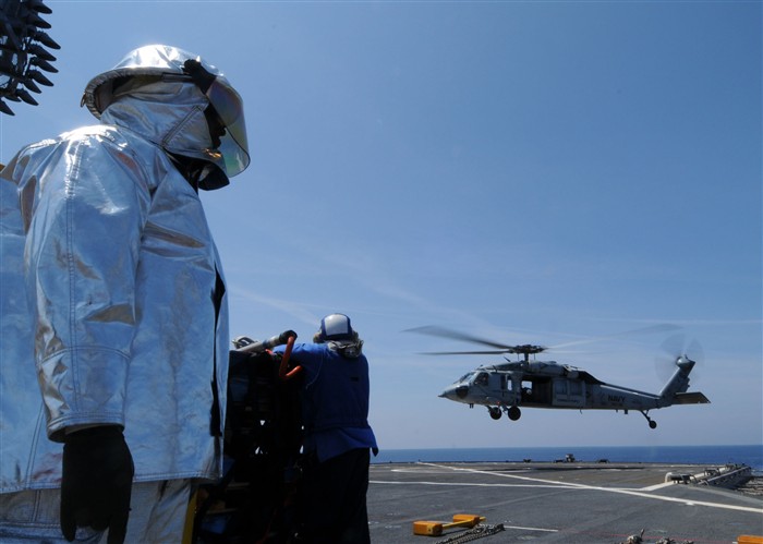 USS MOUNT WHITNEY, Mediterranean &mdash; Demetrius Dickens, Military Sealift Command sailor, stands by in fire safety gear as Helicopter Sea Combat Squadron (HSC) 28 perfroms training flight operations aboard USS Mount Whitney (LCC/JCC 20) April 20. Mount Whitney is currently underway on a routine deployment conducting routine training at sea. (U.S. Navy photo by Mass Communication Speciailst 3rd Class Petty Officer Kristopher Regan)