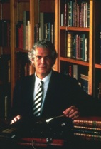 Donald A. B. Lindberg, M.D., seated at a table with historical books on the table.