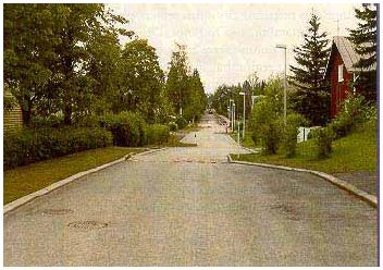 Picture shows a street that has various traffic calming elements, including curb extensions and chicanes.