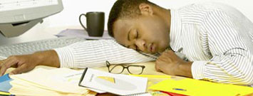 Photo: A man sleeping at his office desk.