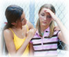 Teenage girl consoling friend.