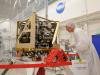 James Bell examines the integrated propulsion system for LADEE, the Lunar Atmosphere and Dust Environment Explorer in a cleanroom at NASA’s Ames Research Center.