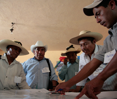 Group of Mexican Men studying map of protected area. Credit: USFWS