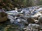 Photo of a stream with boulders in the streambed.