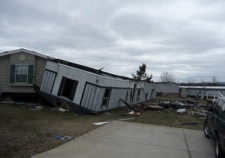 Image of upside down mobile home after a tornado has struck. Click for larger image.