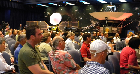 As part of a celebration of 35 years of flight for NASA's Voyager spacecraft, a crowd of engineers and scientists at NASA's Jet Propulsion Laboratory