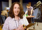 Woman in TV studio holding clipboard