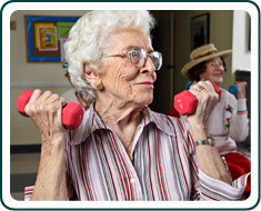 An elderly woman using hand weights.
