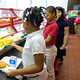 Three school girls of color in a cafeteria lunch line