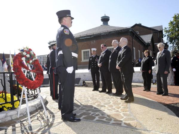 Glenn Gaines, Deputy U.S. Fire Administrator for the U.S. Fire Administration, stands with Craig Fugate, FEMA Administrator, as they honor firefighters who lost their lives at the National Fallen Firefighter memorial service.