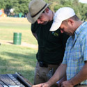 Two researchers examining a soil core