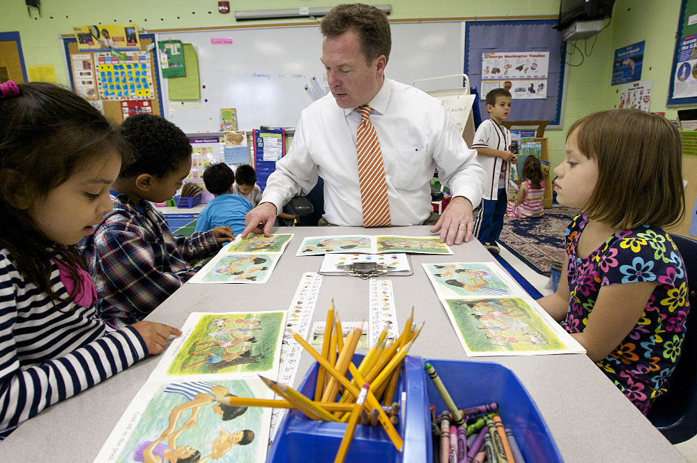 Steven Hicks speaking with children in a classroom.