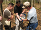 A biologist in the Charleston District regulatory division shows cadets from The Citadel how to use a soil chart to determine wetlands.