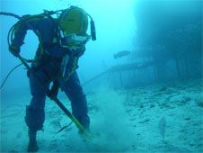 Aquanaut shoveling underwater