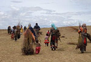 The beginnings of reformation-turning a desert into grasslands: Villagers carry seedlings to start re-plantation activities that