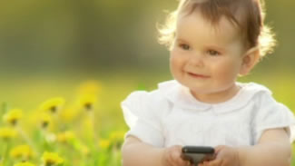 image of a baby holding a cell phone