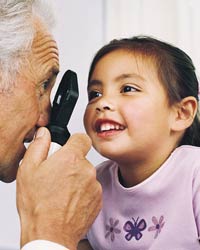 Photo: A girl having her eyes examined