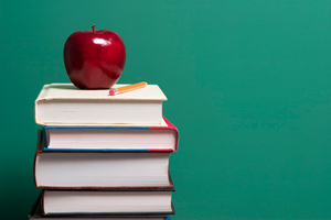 stack of books with an apple on top