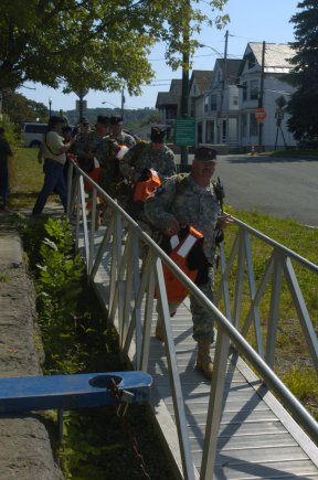 Members of a New York Guard (state defense force) Search and Rescue Team prepare to board a New York Naval Militia patrol boat during a hurricane relief exercise, Sept. 14, 2012,at Troy, N.Y.  Members of the National Guard, Air National Guard, New York Guard and New York Naval Militia, who normally train separately, all came together during the exercise.