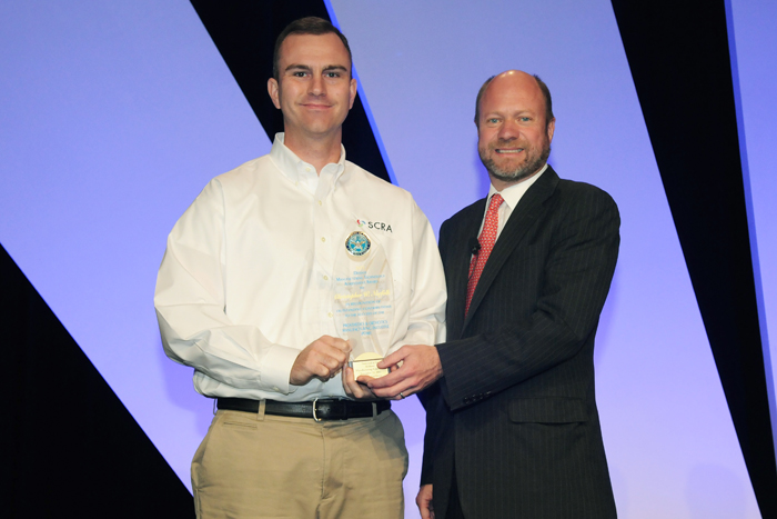 Chris Norfolk accepting 2011 Defense Manufacturing Technology Achievement Award and Mr. Brett Lambert [DASD(MIBP)]