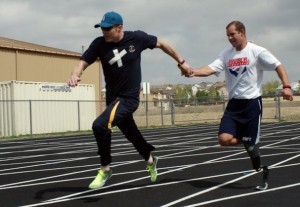Photo of two wounded warriors running in relay event.