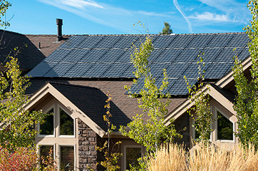 Photo of residential home with roof covered in solar panels