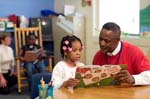 On April 3, 2008, Foster Grandparent Enoch Nelson works with a student on reading comprehension at St. Paul Primary School in Summerton, South Carolina.