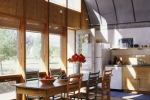 Energy-efficient windows provide space heating and lighting to this sunny kitchen. | Photo courtesy of Emily Minton-Redfield for Jim Logan Architects.
