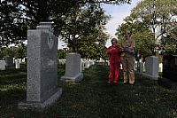 Ima Black, left, widow of the fist Master Chief Petty Officer of the Navy (MCPON), Delbert Black, stands with Chief Operation Specialist Jessica Myers at Arlington Cemetery where she came to visit her late husband's grave. 