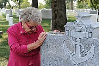 Ima Black, widow of the first Master Chief Petty Officer of the Navy (MCPON), Delbert Black, visits the grave of her late husband.