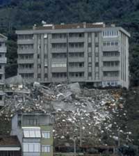 An apartment building is torn apart by an earthquake