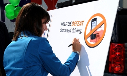 Chairman Deborah Hersman signs a no texting and driving pledge during the Commercial Vehicle Safety Alliance (CVSA) event on September 24, 2012. 