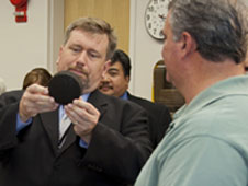 Michael Hogue shows regolith heat shield sample to NASA chief technologist.