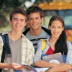 a photo of three students standing outside